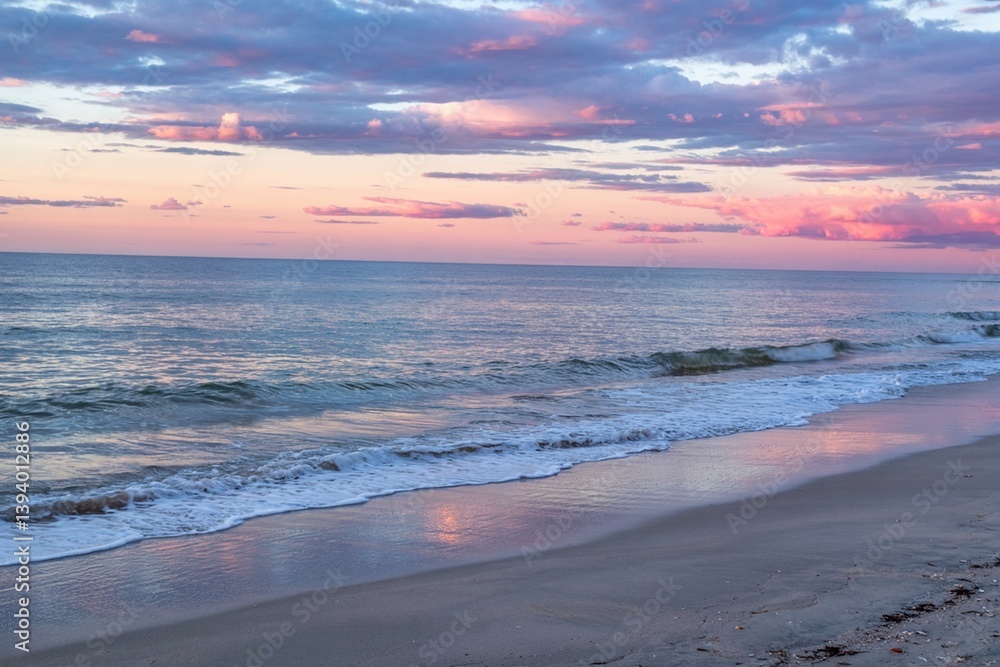 Tranquil Beach Scene With Soft Waves And Pink Clouds At Sunrise Tranquil Beach Scene With Soft Waves And Pink Clouds At Sunrise