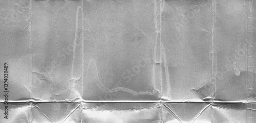 Milk package die-cut - crumpled silver foil texture with folded package. Metallic plastic-coated food packaging for background of creative poster designs, banners or covers