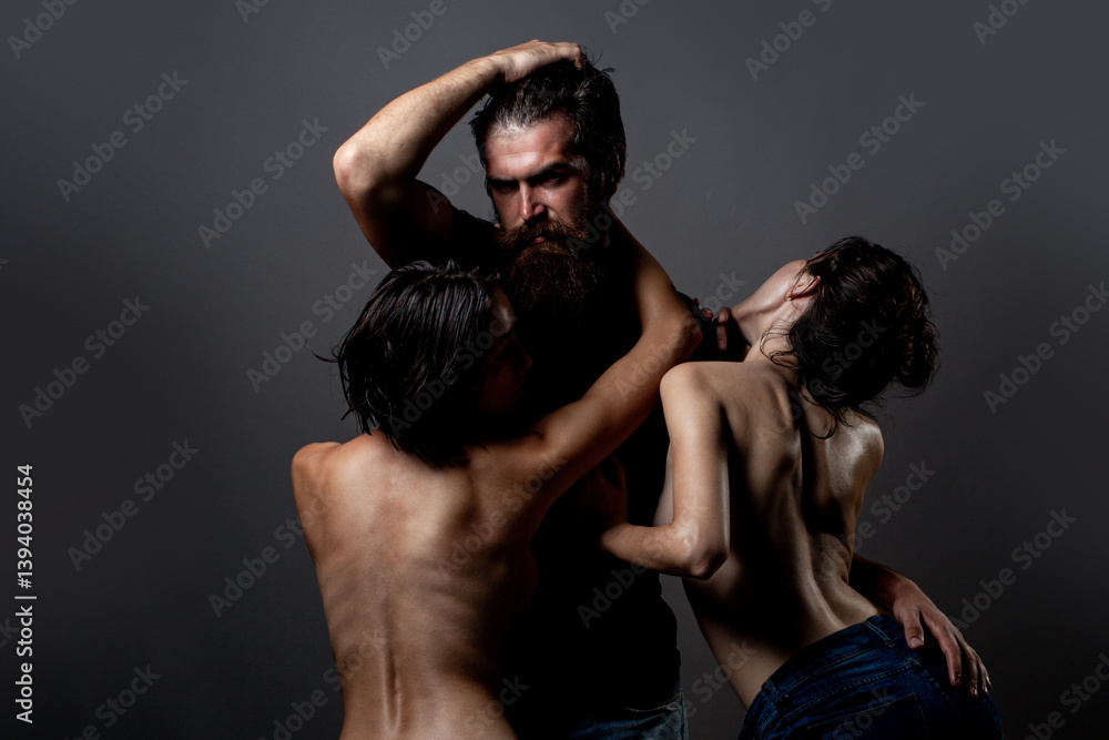 Threesome concept. Three sexy models together. One man and two sexy women. Polygamy or bigamy. Swinger or trio. Bisexual lady. Prostitution or fantasy. Polyamory and polygamy. Romantic of Threesome.