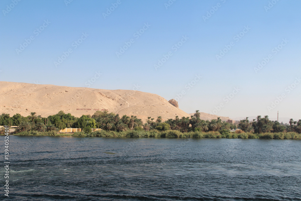 Fototapeta premium Landscape of the magical blue Nile River in upper Egypt with the signboard-Welcome to Aswan
