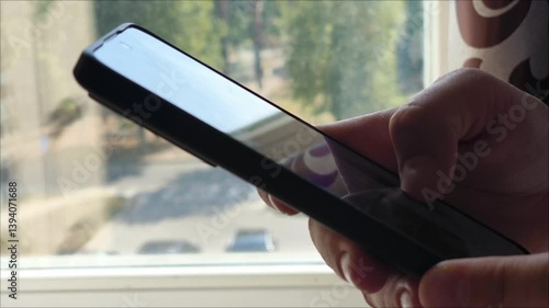 Millennial generation z female scroll through news feed on app on her phone. hands close up scrolling gadget addicted female girl user influencer holding sliding with fingers using smartphone internet