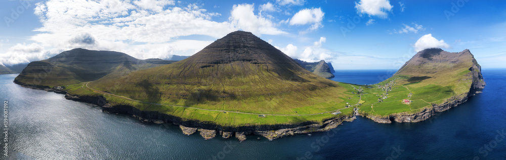 Fototapeta premium Aerial landscape photography. Amazing summer view from flying drone of Vidareidi village. Beautiful summer scenery. Sunny outdoor scene of Vidoy island, Faroe Islands, Denmark, Europe.