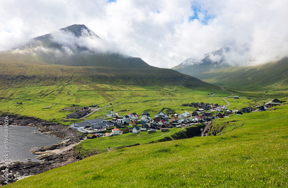 Fototapeta premium Faroe islands - Village of Gjogv on cliffs washed by the ocean, Eysturoy - Denmark, Europe