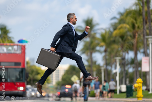 Obraz na płótnie Business jump. Businessman jumping in the street. Businessman in a suit running late and jump. Busy business man in jump motion. Confident businessman office worker jump up with excitement. w salonie
