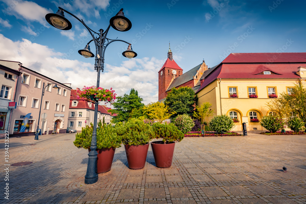Impressive summer view of empty Market Squere in Darlowo town with monumental building of Gothic stile Catholic church. Nice morning cityscape of Darlowo, Poland, Europe.