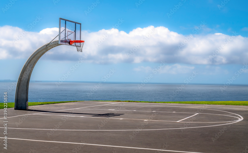 Outdoor basketball court with amazing ocean view and dramatic sky
