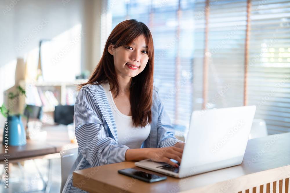 Portrait of asian freelance teenage people business woman casual working with laptop computer in cafe interior in coffee shop background,business expressed confidence embolden and successful concept
