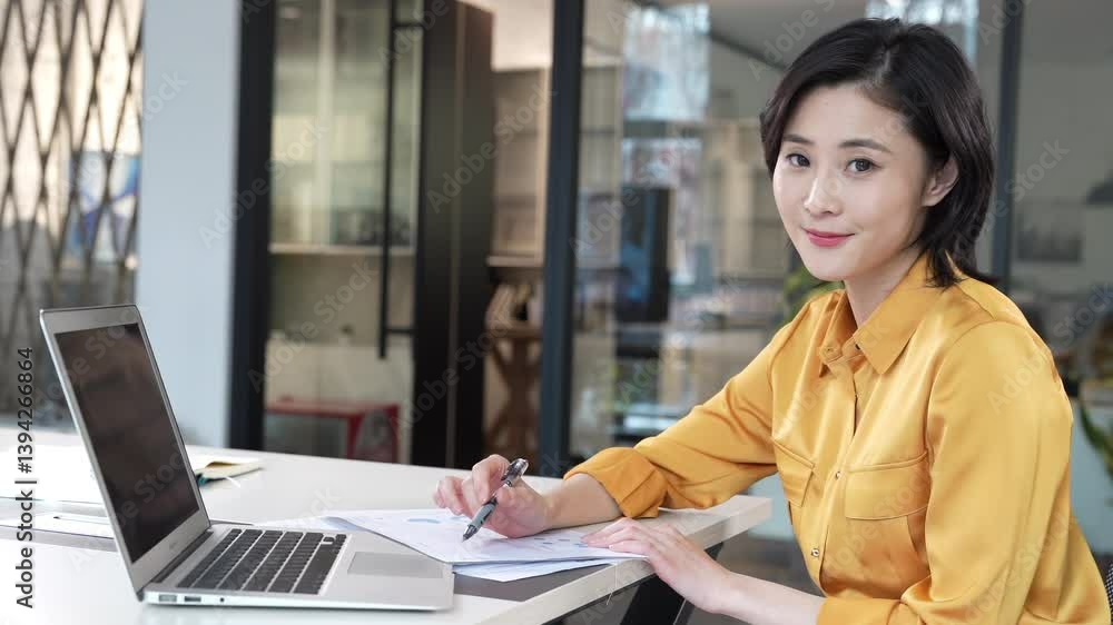 Portrait of happy young business woman executive using laptop in office. Smiling businesswoman company employee sitting at work desk, professional female hr manager looking pc computer at workplace Portrait of happy young business woman executive using laptop in office. Smiling businesswoman company employee sitting at work desk, professional female hr manager looking pc computer at workplace