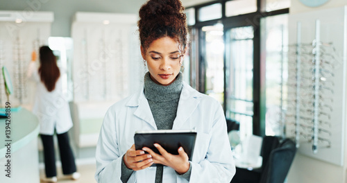 Tablet, woman and optometrist in shop for vision, eyecare or wellness report online. Reading, research and female optician with digital technology for checking ophthalmology appointment in store.