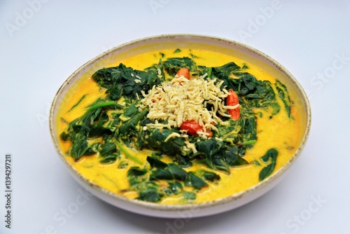 Gulai Daun Ubi is an Indonesian dish made with cassava leaves cooked in rich coconut milk and spices. A flavorful and creamy curry, popular in Sumatra and other regions.