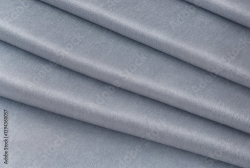 Abstract background made of natural gray fabric folded in several layers. Luxurious textile wallpaper
