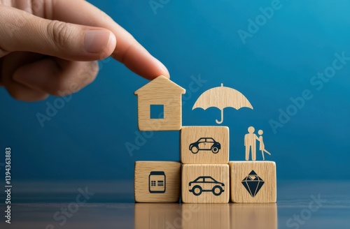 Protecting assets with insurance.  Wooden blocks represent home, car, family, and valuables, all under an umbrella of protection