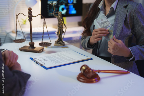 Businesswoman putting a wad of cash into her jacket pocket during a contract signing, suggesting bribery and corruption in a law office setting with scales of justice and gavel