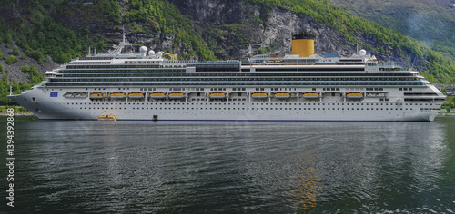 Modern mega cruiseship cruise ship liner Favolosa in Geirangerfjord with panoramic views of Geiranger and the breathtaking mountain scenery and fjord landscape nature during Norway cruising
