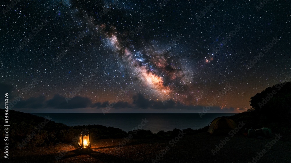 Fototapeta premium Starry night sky over ocean with lantern coastal landscape night photography serene atmosphere wide-angle view