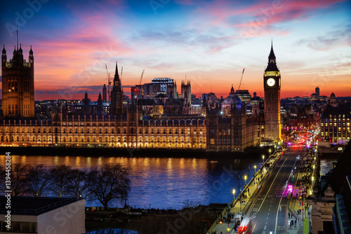 Obraz na płótnie Elevated view of the illuminated Westminster Palace and Big Ben clock tower in London, England, during a colorful evening w salonie
