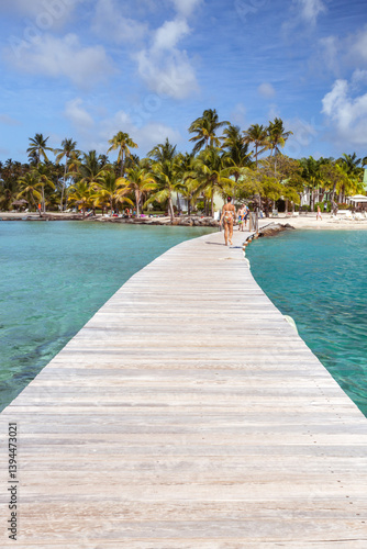 Wallpaper Mural Woman walking on jetty leading to a tropical island in the Caribbean, Martinique Torontodigital.ca