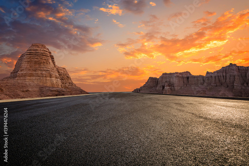 Bilde på lerret Asphalt road and Yardang landform mountain with beautiful sky clouds at sunset