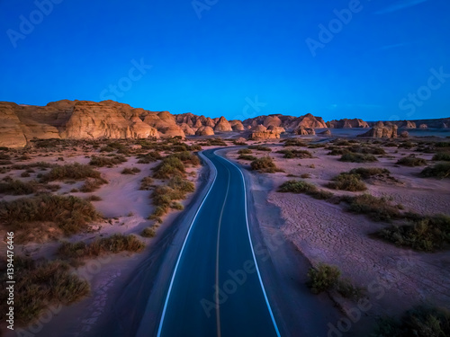 Obraz na płótnie Aerial view of a road through the desert landscape at twilight. Famous Dahaidao no man's land natural scenery in Xinjiang, China. w salonie