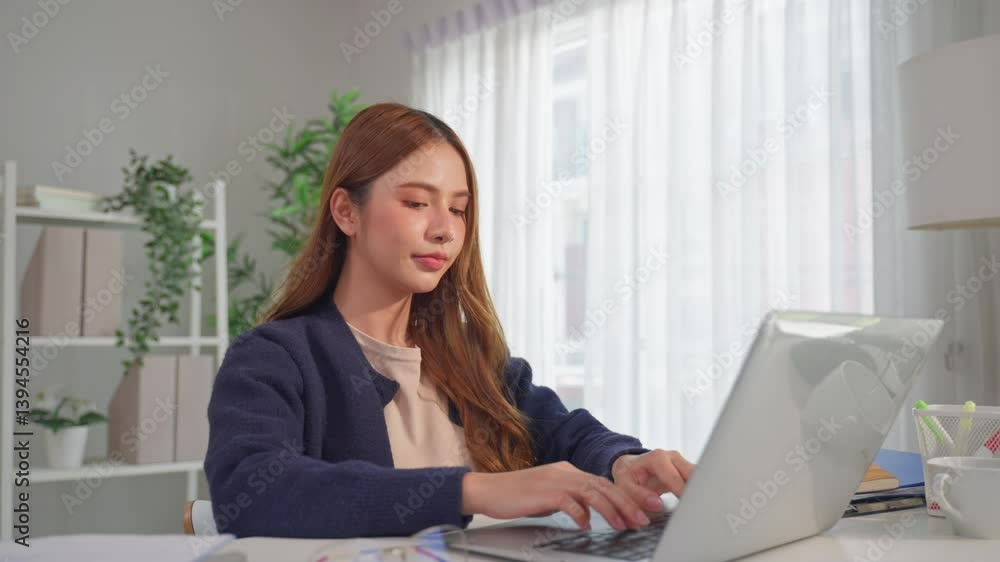 Asian attractive woman freelancer using laptop device working in house. Asian attractive woman freelancer using laptop device working in house.