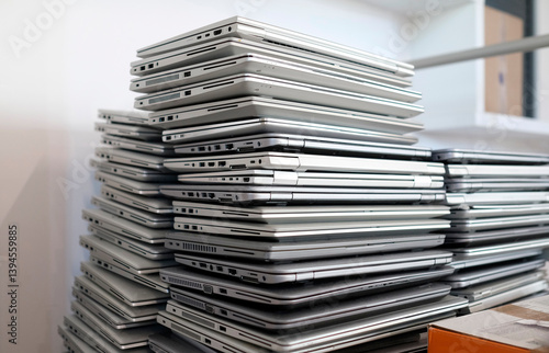 Electronic waste - stack of laptops to be discarded