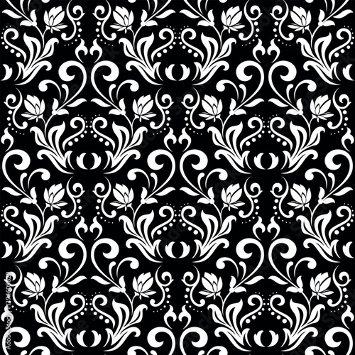Wallpaper in the style of Baroque. Seamless vector background. White and black floral ornament. Graphic pattern for fabric, wallpaper, packaging. Ornate Damask flower ornament.
