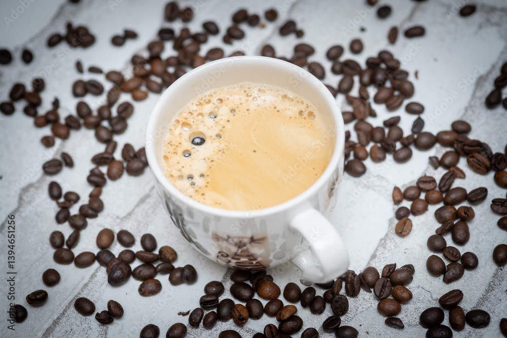 Top-down view of a delicious cup of coffee next to scattered coffee beans—perfect for café promotions, morning routines, and coffee lover content. Warm, inviting, and full of aroma. Top-down view of a delicious cup of coffee next to scattered coffee beans—perfect for café promotions, morning routines, and coffee lover content. Warm, inviting, and full of aroma.