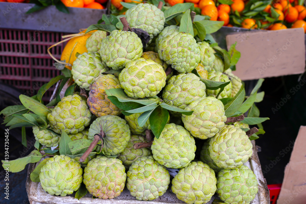 Fototapeta premium Fresh custard apple fruits for sale at a local market in Vietnam.