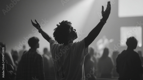 Black and white worship concert photography with crowd and man raising hands in praise and adoration