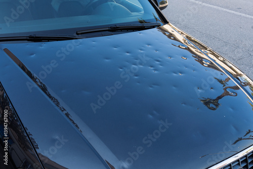 car hood hit by hail. storm damage