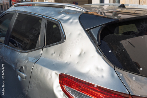 side of car hit by hail. storm damage