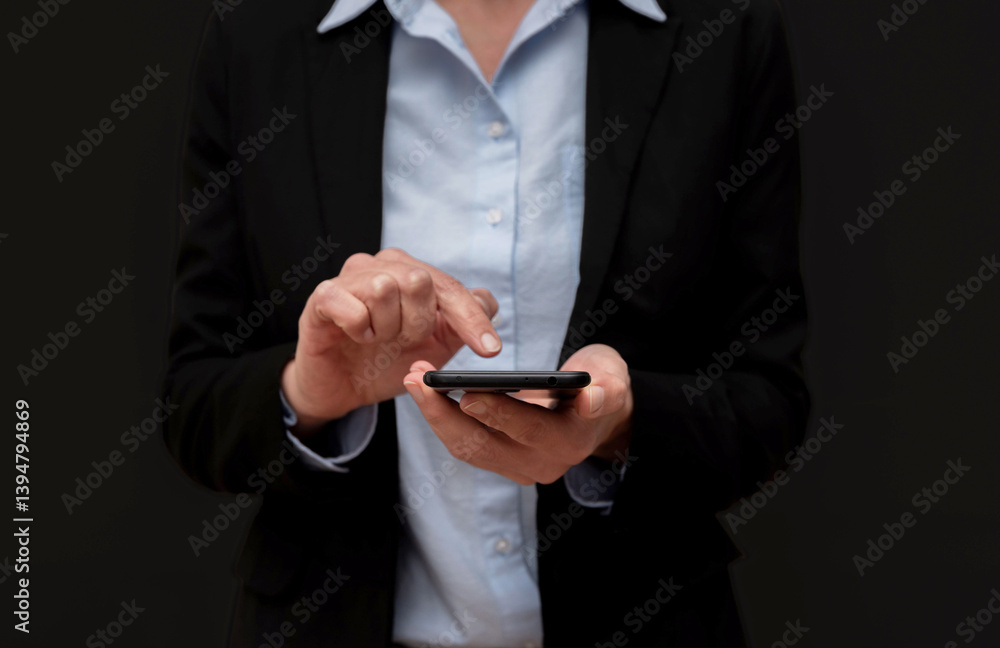 Close up of Businesswoman using smartphone, browsing internet, reading news, checking email on black background Close up of Businesswoman using smartphone, browsing internet, reading news, checking email on black background