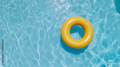 Yellow inflatable ring floats in a refreshing blue swimming pool, summer vibes.