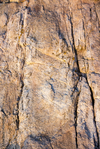 Obraz na płótnie natural sea rock texture with crack. outdoor background of sandstone surface in morning light. closeup of rough stone on coast terrain. dry environment w salonie