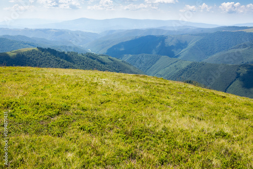 Obraz na płótnie rolling scenery with grassy alpine meadow. view to valley. scenic carpathian mountain landscape of borzhava ridge. popular travel destination of ukraine on a sunny day in summer. clouds above horizon w salonie