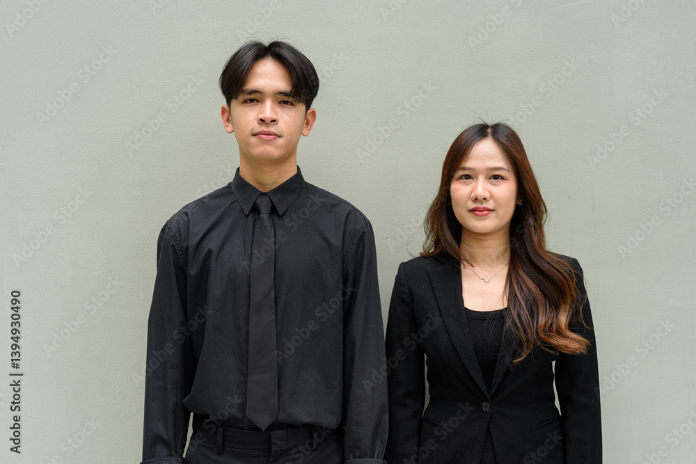 Portrait of young Asian couple wearing business uniform Portrait of young Asian couple wearing business uniform