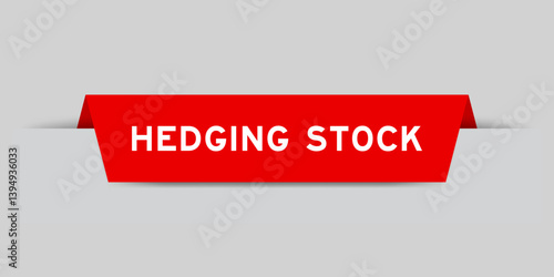 Red color inserted label with word hedging stock on gray background