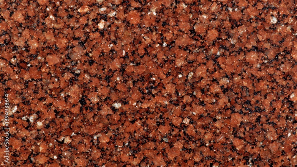 A close-up view of a coarse, reddish-brown granular surface, resembling sand or mineral texture, showcasing various small particles and colors. A close-up view of a coarse, reddish-brown granular surface, resembling sand or mineral texture, showcasing various small particles and colors.