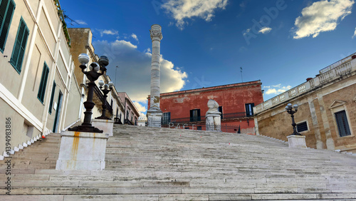 Roman Columns and Virgilian Staircase in Brindisi with Historic Architecture and Dramatic Sky. Puglia, Italy