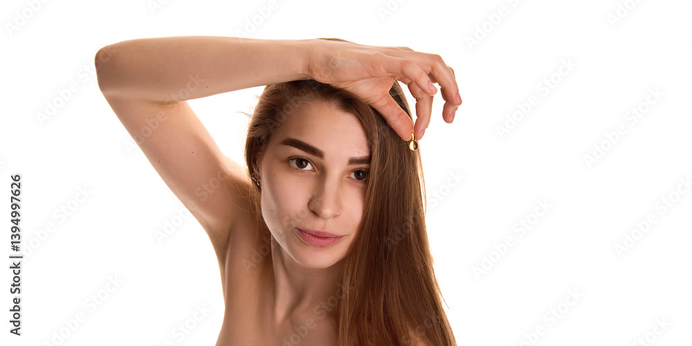 Obraz premium Portrait of young attractive woman with long well-groomed shiny hair, showing oil-capsule for hair treatment against white background. Concept of youth and natural beauty, cosmetic, spa. Ad