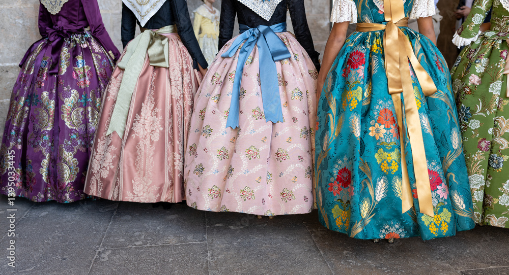 Unknown falleras dress from Valencia Fallas fest in a row at Spain.
