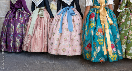 Obraz na płótnie Unknown falleras dress from Valencia Fallas fest in a row at Spain. w salonie