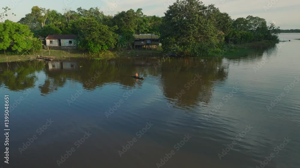Aerial View of Man Rowing a Small Boat on Amazon River Tributary Near Santa María de Ojeal - Drone Footage Aerial View of Man Rowing a Small Boat on Amazon River Tributary Near Santa María de Ojeal - Drone Footage