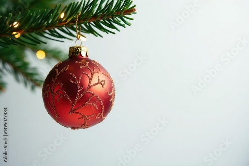 Ornament in shape of leaf hanging from Christmas tree branch on white background, sparkling, mirror, festive