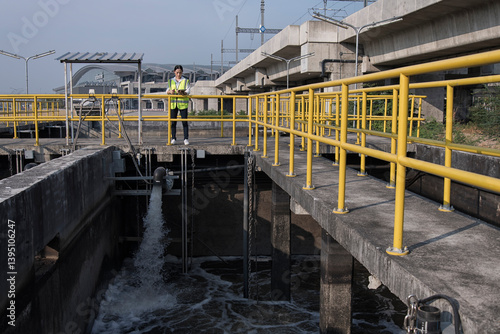 service engineer checking on waste water treatment plant with pump on background. worker working on Waste water plant.	
