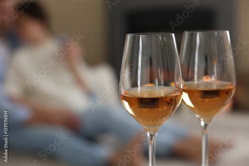 Obraz na płótnie Couple near fireplace at home, focus on glasses of wine w salonie