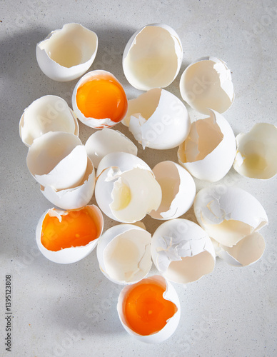 cracked eggs on surface with shells and yolks