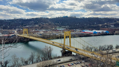 Pittsburgh, Pennsylvania, USA – March 18, 2024: The 10th Street Bridge spans the Monongahela River, connecting South Side to downtown under a partly cloudy sky.