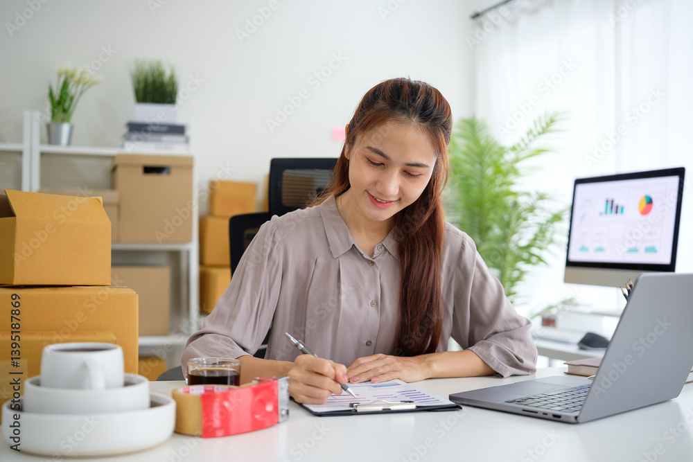 Young entrepreneur working in her home office, checking inventory and analyzing sales data while surrounded by shipping boxes and e-commerce supplies. Young entrepreneur working in her home office, checking inventory and analyzing sales data while surrounded by shipping boxes and e-commerce supplies.