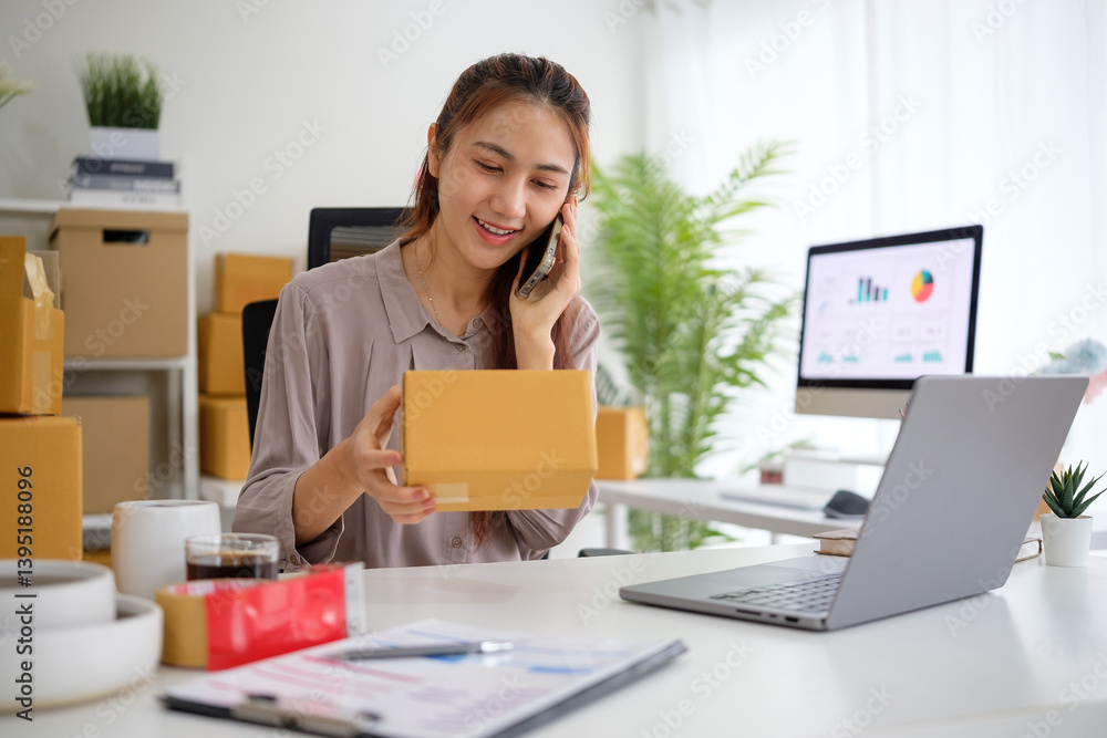 Woman in a modern workspace communicating with a client on the phone while managing product packaging, with a laptop and shipping materials on her desk. Woman in a modern workspace communicating with a client on the phone while managing product packaging, with a laptop and shipping materials on her desk.